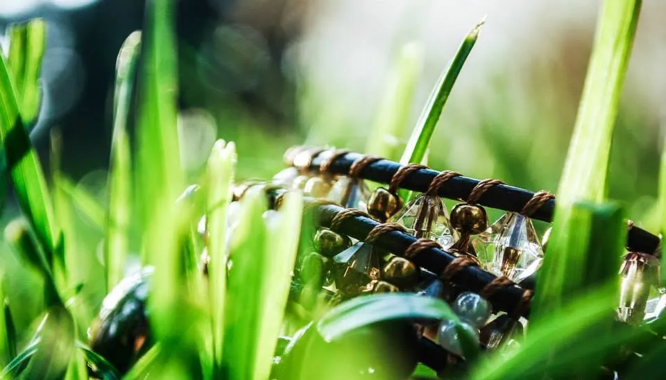 Close-up of crystal beads and leather in the grass